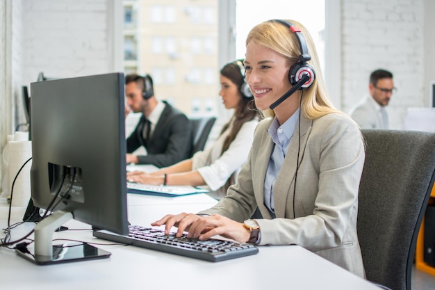 Blonde business woman with headset working in call center