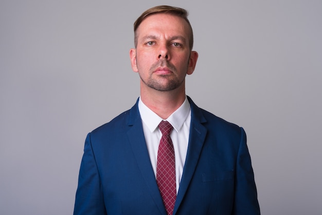 blonde businessman wearing blue suit