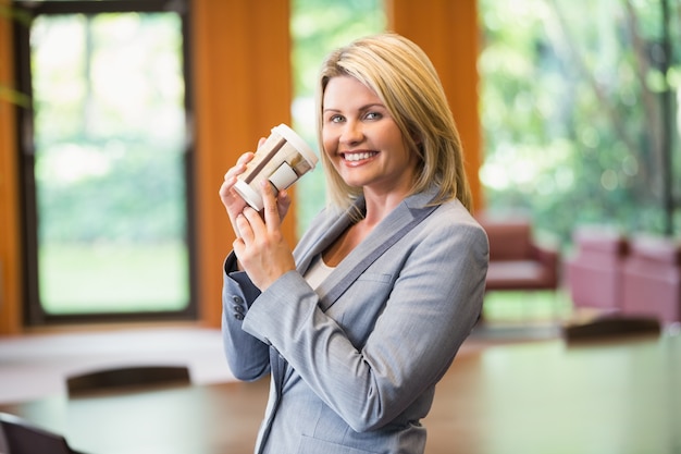 Blonde businesswoman having a coffee