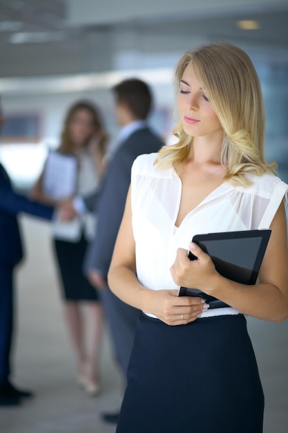 Blonde businesswoman looking at camera