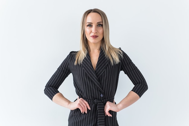 Blonde businesswoman in suit posing