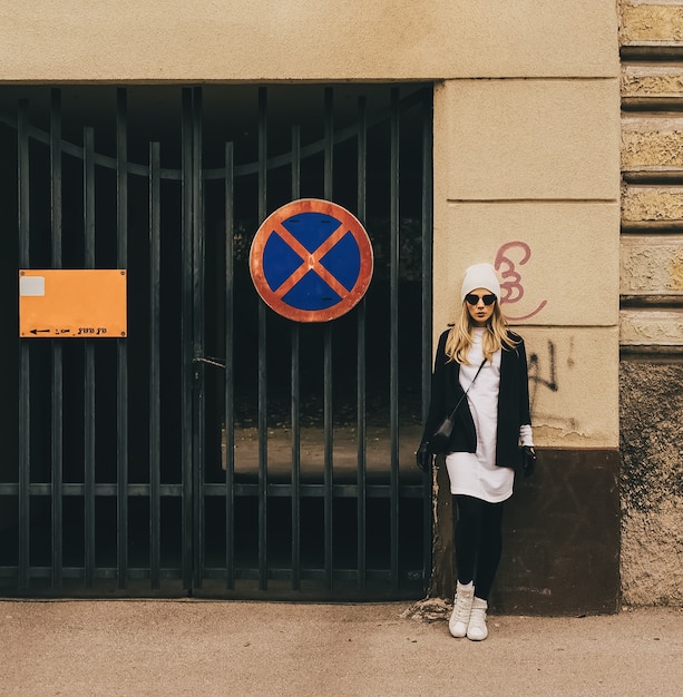 Blonde on city street. Trendy urban Loock. Black and white fashion style