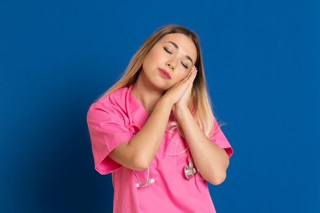 Blonde doctor with pink uniform