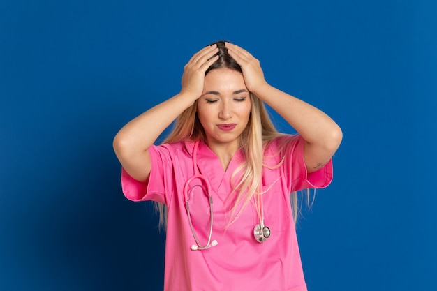 Blonde doctor with pink uniform