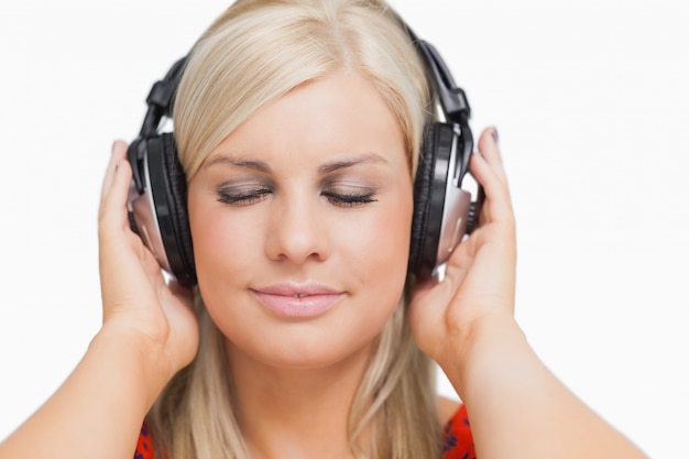 Blonde in dress listening to music