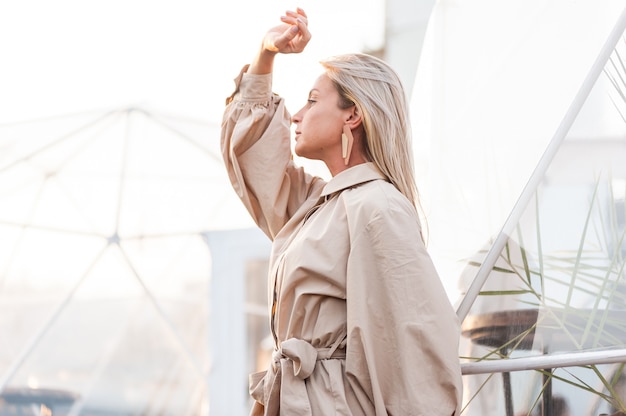 Blonde fashion posing near a metal structure