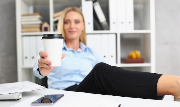 Photo blonde female lift hot cup of coffee drink pause from work cheers