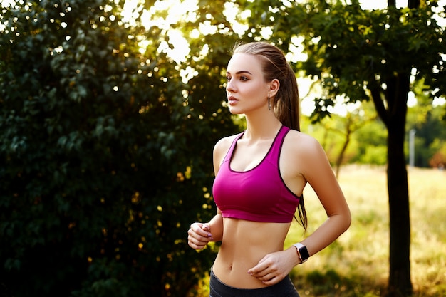 Blonde girl doing exercises in the park