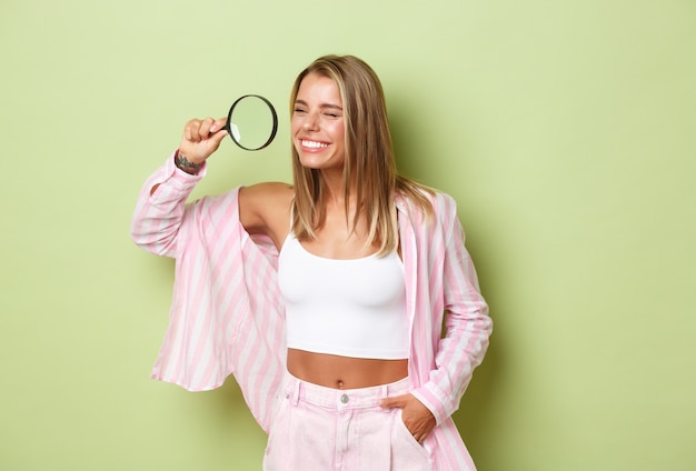 Blonde girl in a pink outfit posing