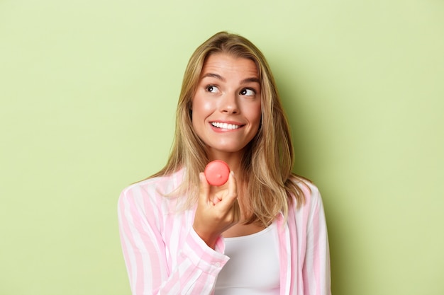 Blonde girl in a pink outfit posing