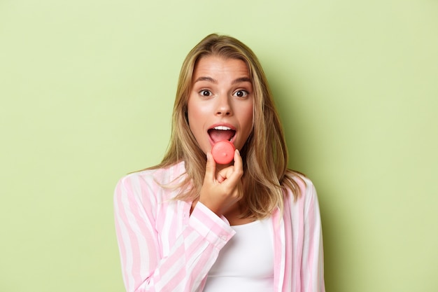 Blonde girl in a pink outfit posing