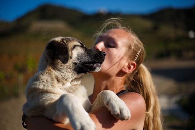 Blonde girl playing with spanish mastiff puppy