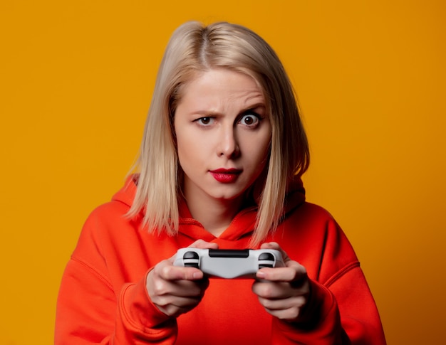 Blonde girl plays with a joystick