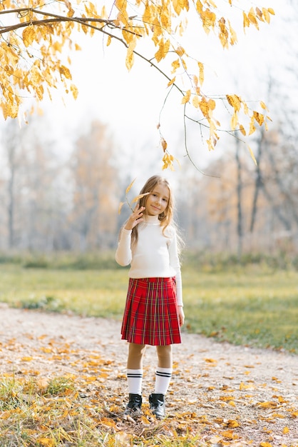 Blonde girl posing in autumn park