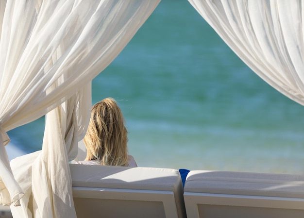 blonde girl sitting in the gazebo