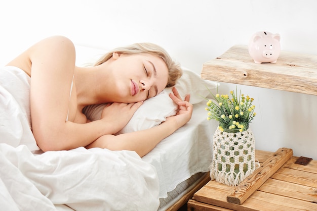 Blonde girl sleeping in daylight