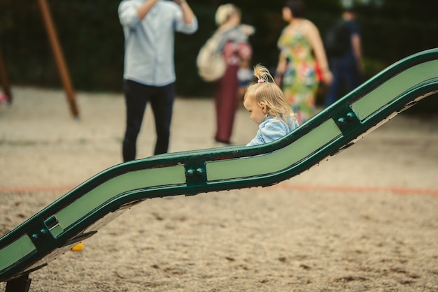 Blonde girl on the slide