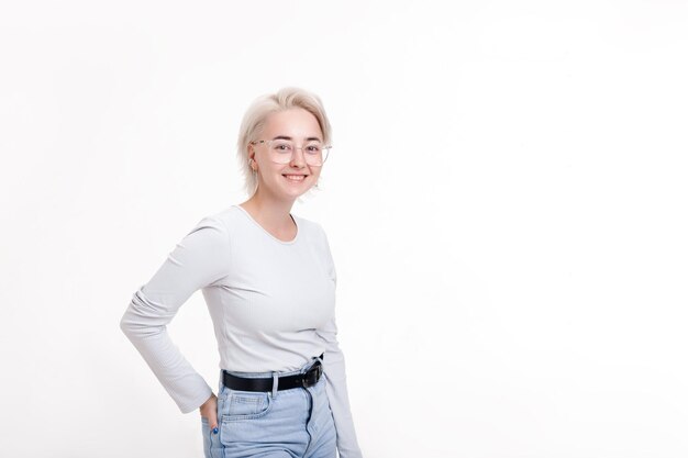 Blonde girl smiles broadly on a white background