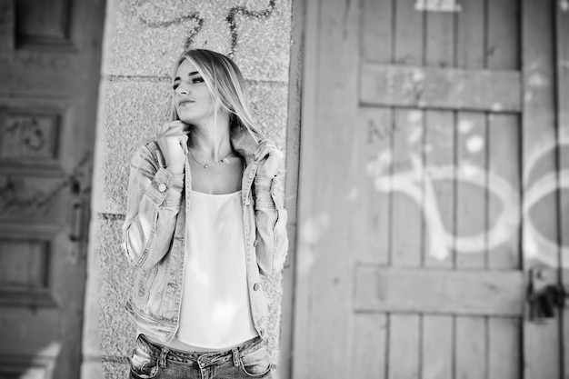 Blonde girl wear on jeans jacket posed at street