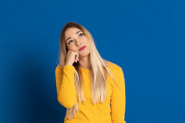 Blonde girl wearing a yellow T-shirt