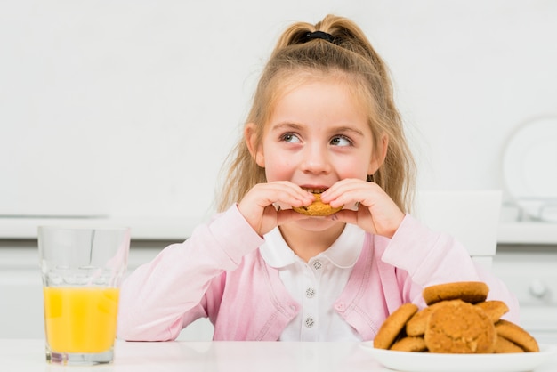 Blonde girl with cookies and juice