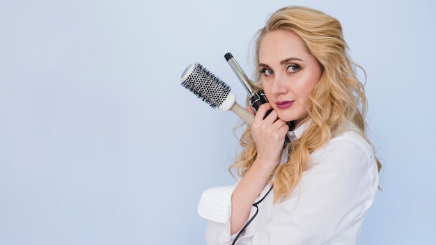 blonde girl with hair brushes
