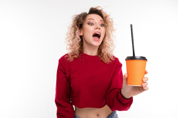 blonde girl with open mouth and with a plastic glass on white