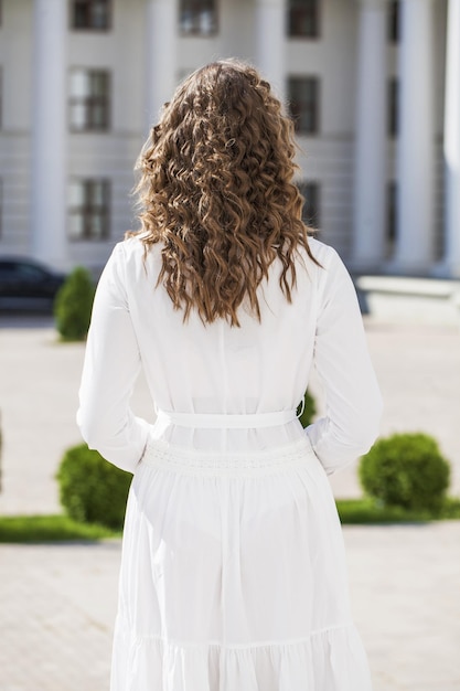 Blonde hair model Back view blonde girl summer park outdoor