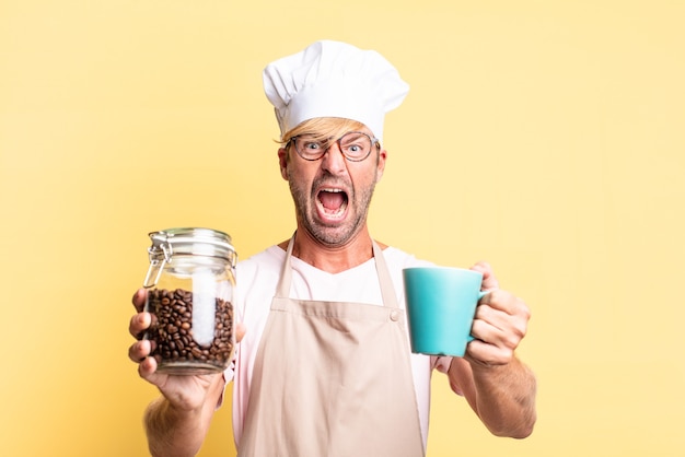 Blonde handsome chef  adult man holding a coffee beans bottle