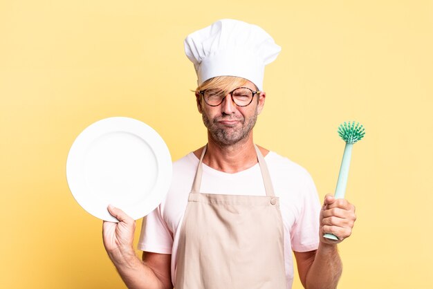 blonde handsome chef  adult man with an empty dish