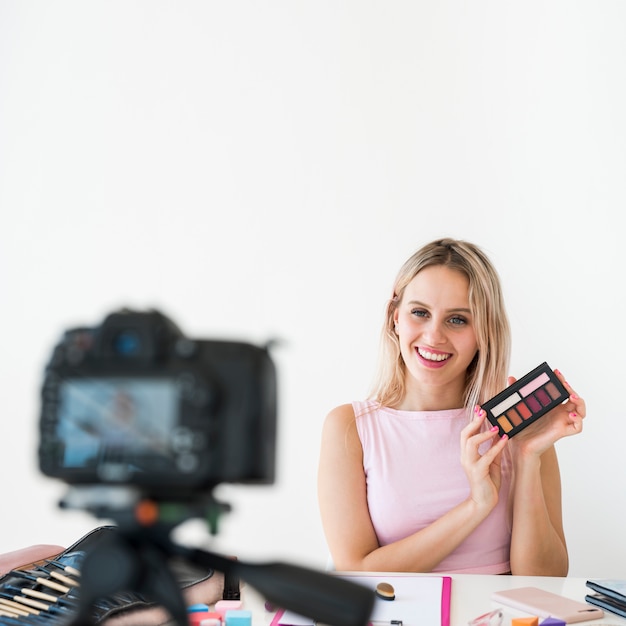 Photo blonde influencer recording make up video