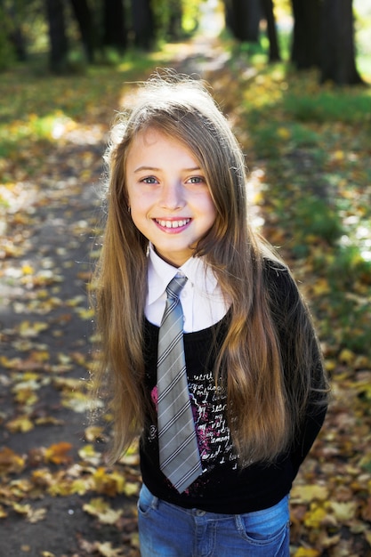 Blonde little princess in a park