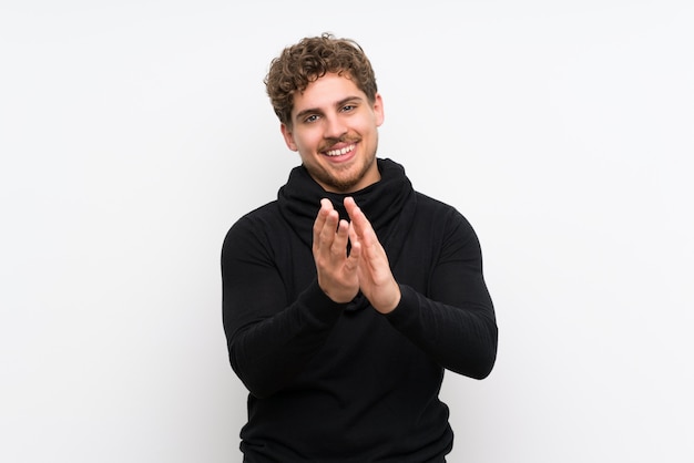 Blonde man applauding after presentation in a conference