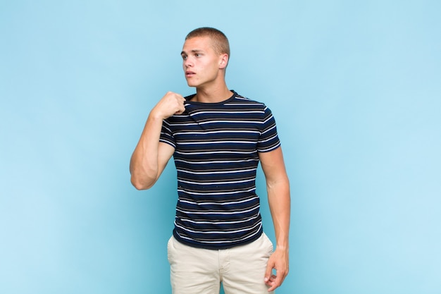 Blonde  man feeling stressed, anxious, tired and frustrated, pulling shirt neck