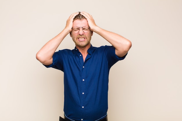 Blonde man feeling stressed and anxious