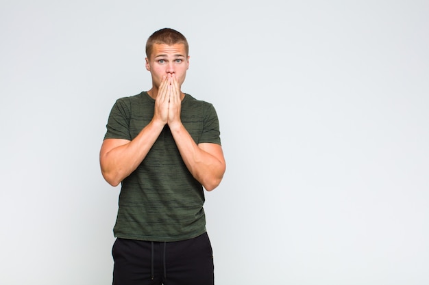 Blonde man feeling worried, upset and scared