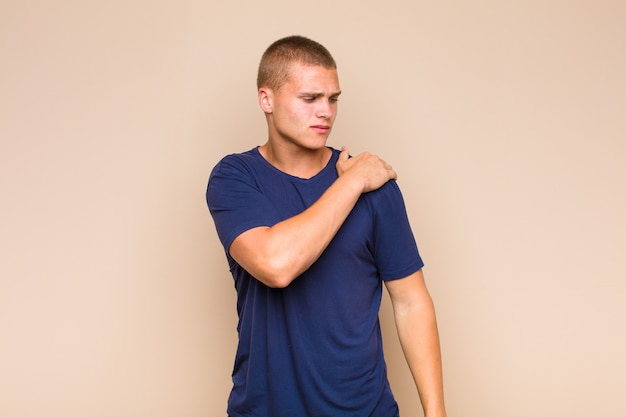 Blonde man having shoulder pain