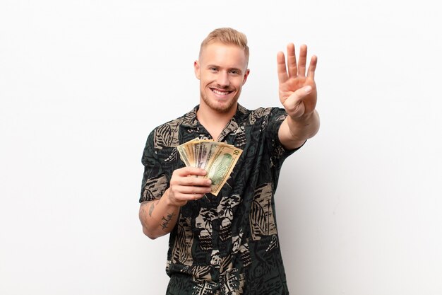 blonde man holding money showing number four or fourth with hand forward