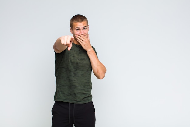 Blonde  man laughing at you, pointing and making fun of or mocking you