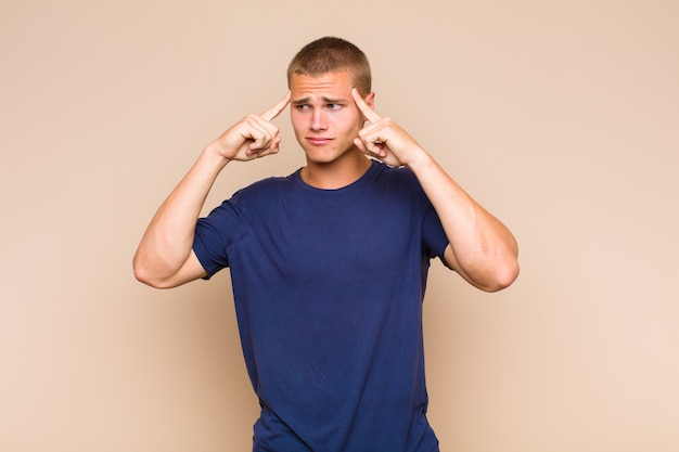 Blonde  man looking concentrated and thinking hard on an idea, imagining a solution to a challenge or problem