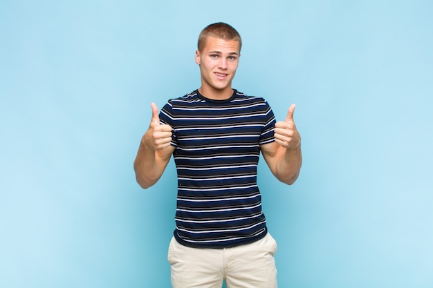 Blonde man smiling broadly with both thumbs up