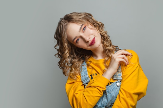 Blonde model girl on gray background