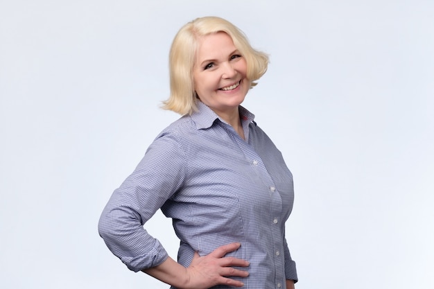 Blonde older woman smiling and looking at camera