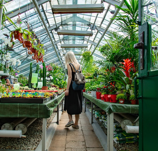 Blonde in the palm greenhouse of the Botanical garden