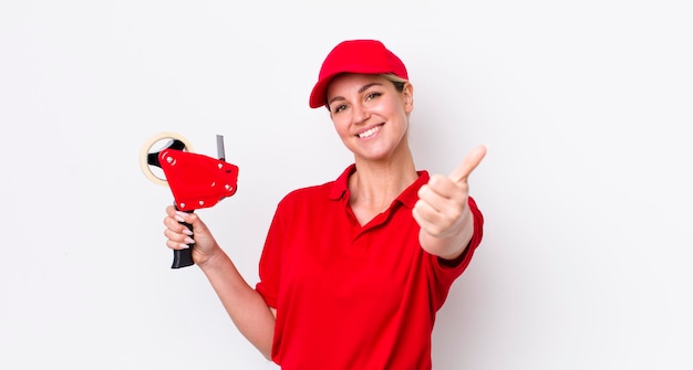 Photo blonde pretty woman feeling proudsmiling positively with thumbs up worker concept