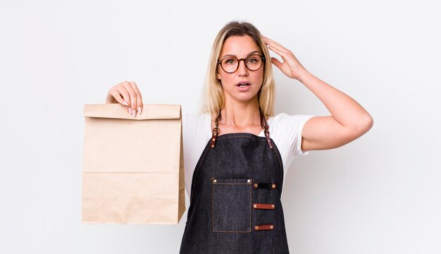 Blonde pretty woman looking happy astonished and surprised delivery take away concept