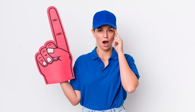 Blonde pretty woman looking surprised realizing a new thought idea or concept number one hand fan concept