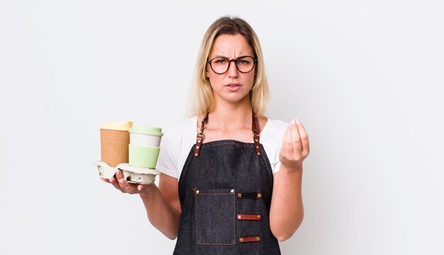 Blonde pretty woman making capice or money gesture telling you to pay take away coffee concept