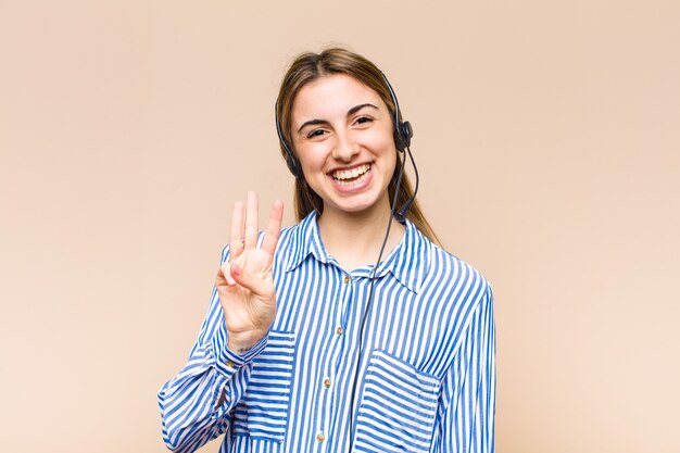 Blonde pretty woman smiling and looking friendly, showing number two or second with hand forward, counting down