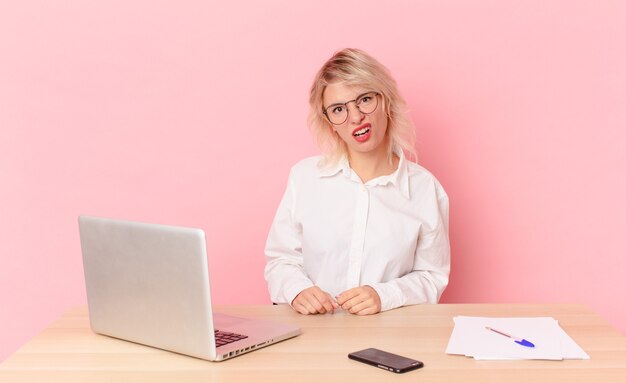 Blonde pretty woman young pretty woman feeling puzzled and confused. workspace desk concept